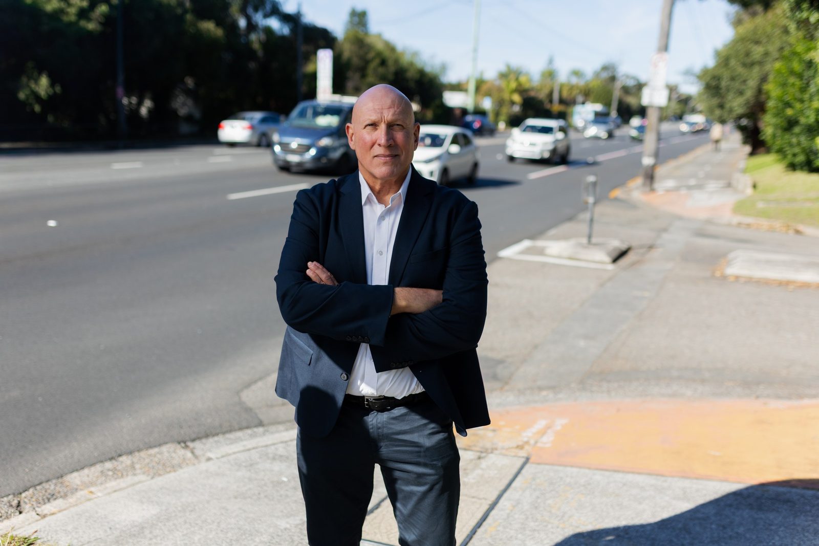 Michael Gencher beside a busy Pittwater road